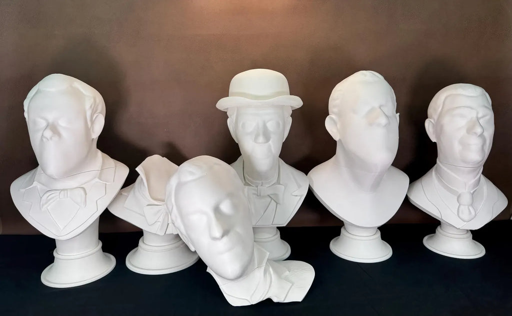 Set of white 3D printed halloween busts on a dark background